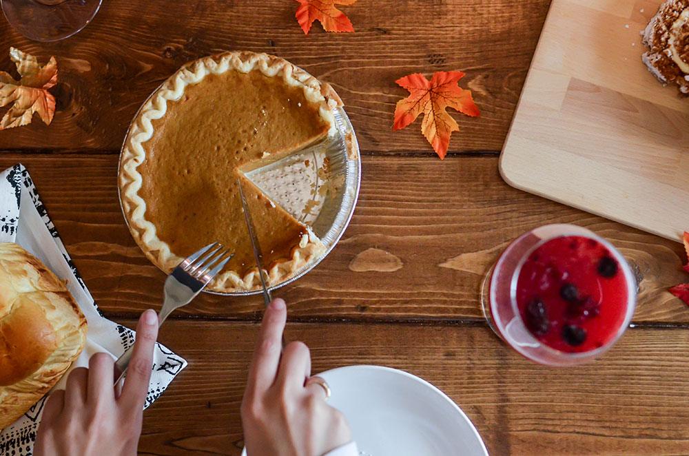 table with pumpkin pie and bread and leaves
