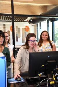 Hallie Wright explains data on a computer screen for students