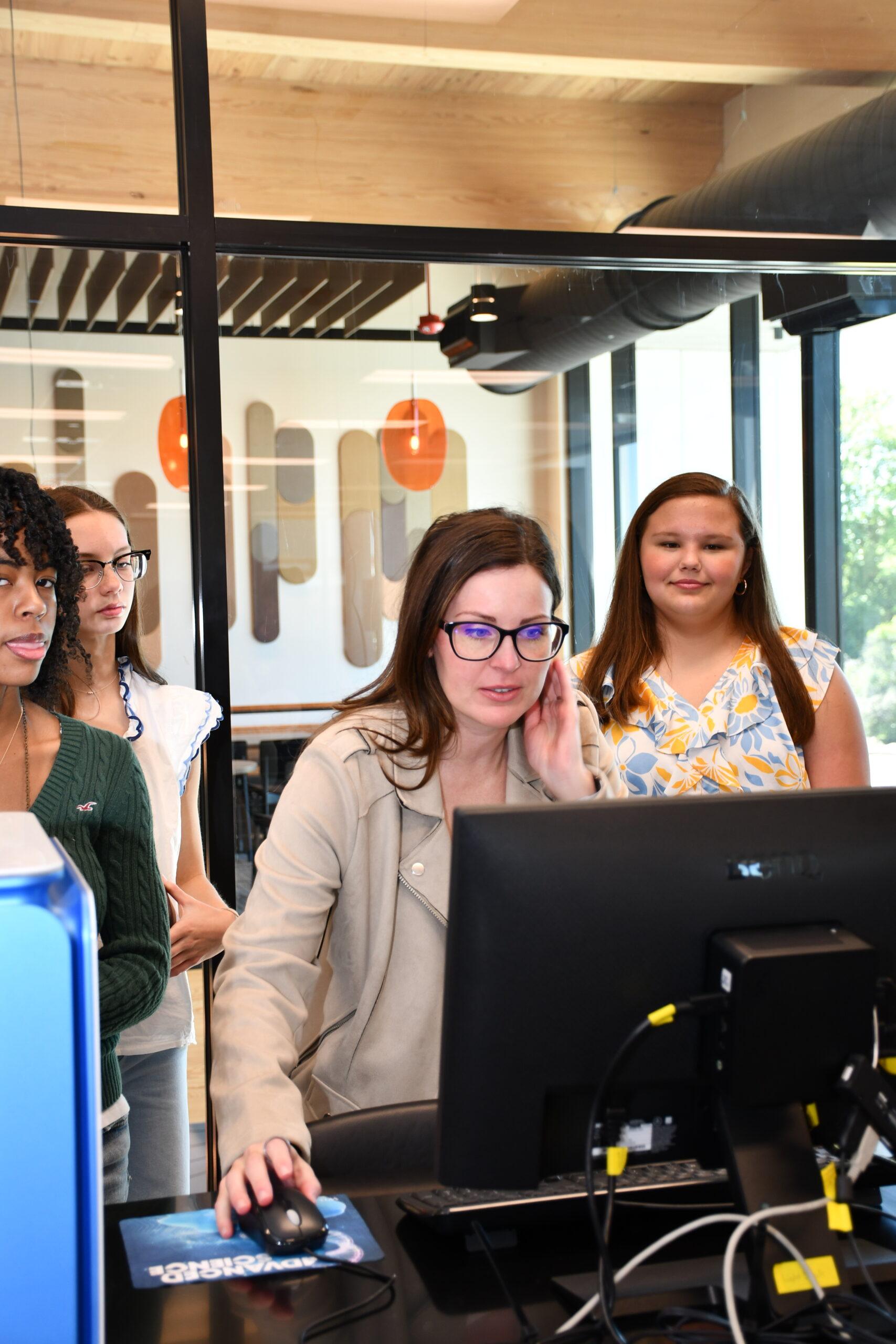 Hallie Wright explains data on a computer screen for students