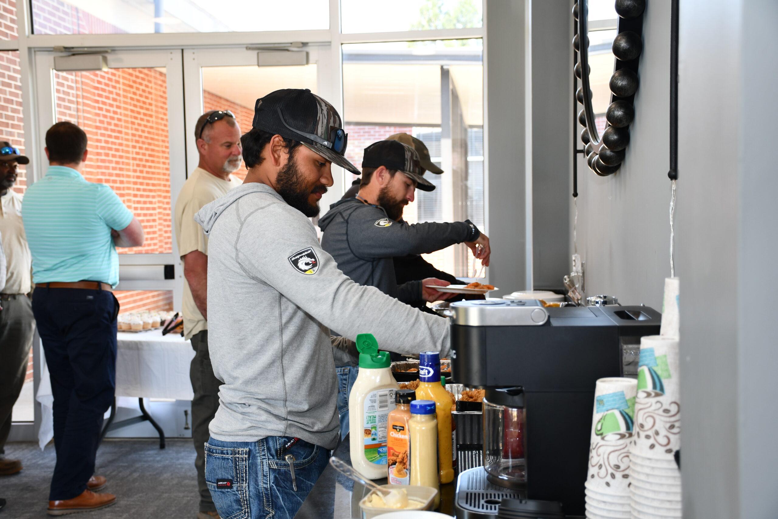 Groundman Ralphy Murillo fills up his plate during a luncheon