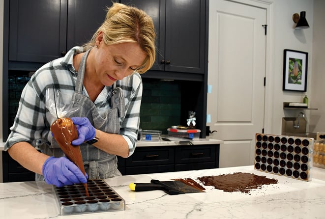 Egbert fills chocolate molds with caramel