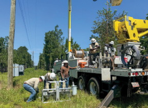 WEC crew works on transmission line