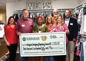 Wiregrass Electric Cooperative management and members of the board of trustees present a grant to the Wiregrass Emergency Pregnancy Service.
