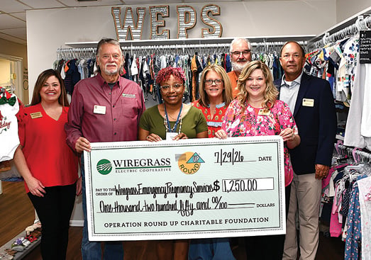 Wiregrass Electric Cooperative management and members of the board of trustees present a grant to the Wiregrass Emergency Pregnancy Service.