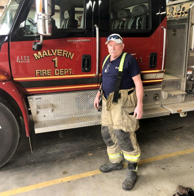 Van Johnston standing next to firetruck