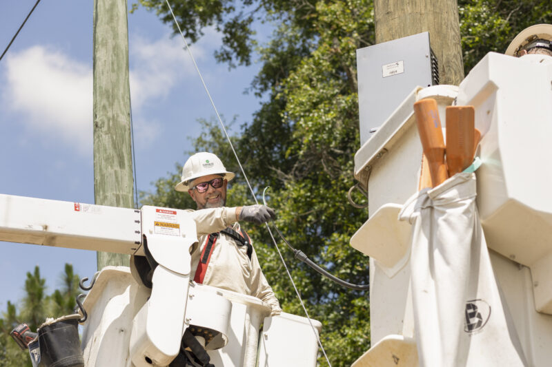 Electricity Lineman working on a pole in a bucket truck
